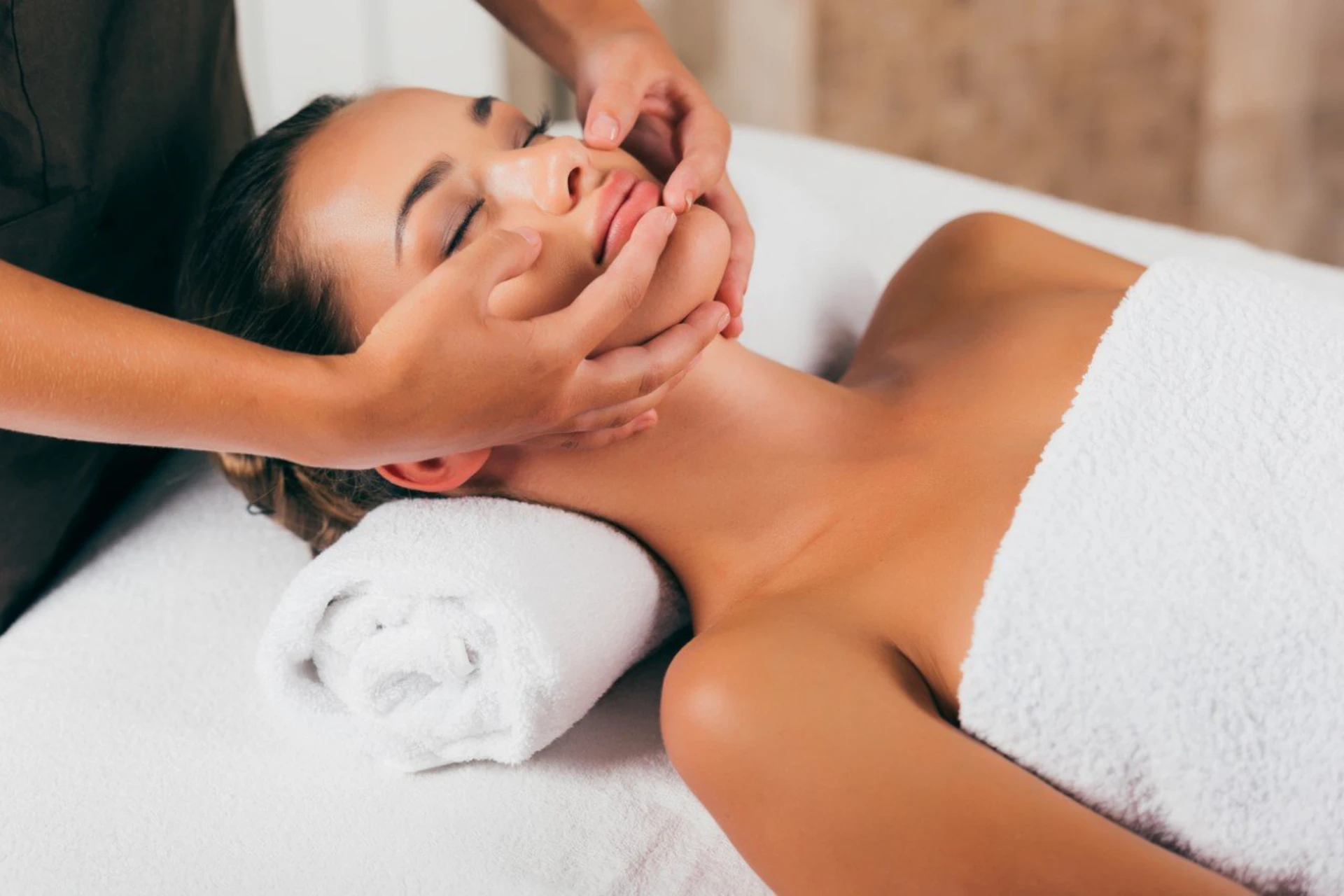 Woman enjoying facial massage at home in Bali