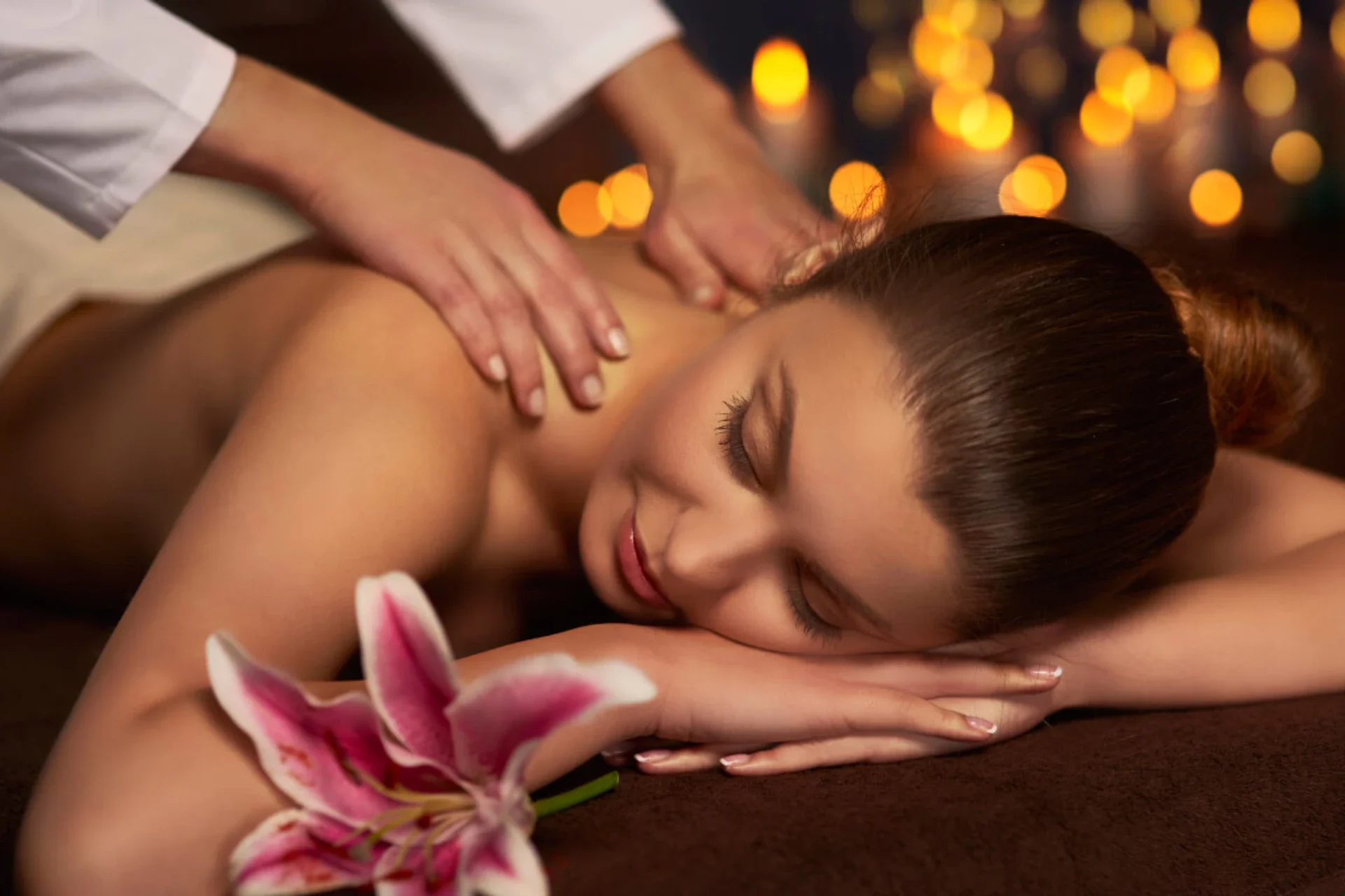 Client enjoying traditional massage in villa garden